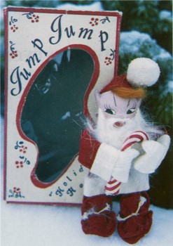 A Jump Jump doll in a Santa Claus suit.